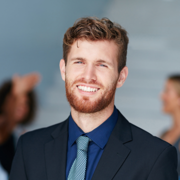 portrait-of-a-young-businessman-standing-in-an-off-2023-11-27-04-53-36-utc-1.png